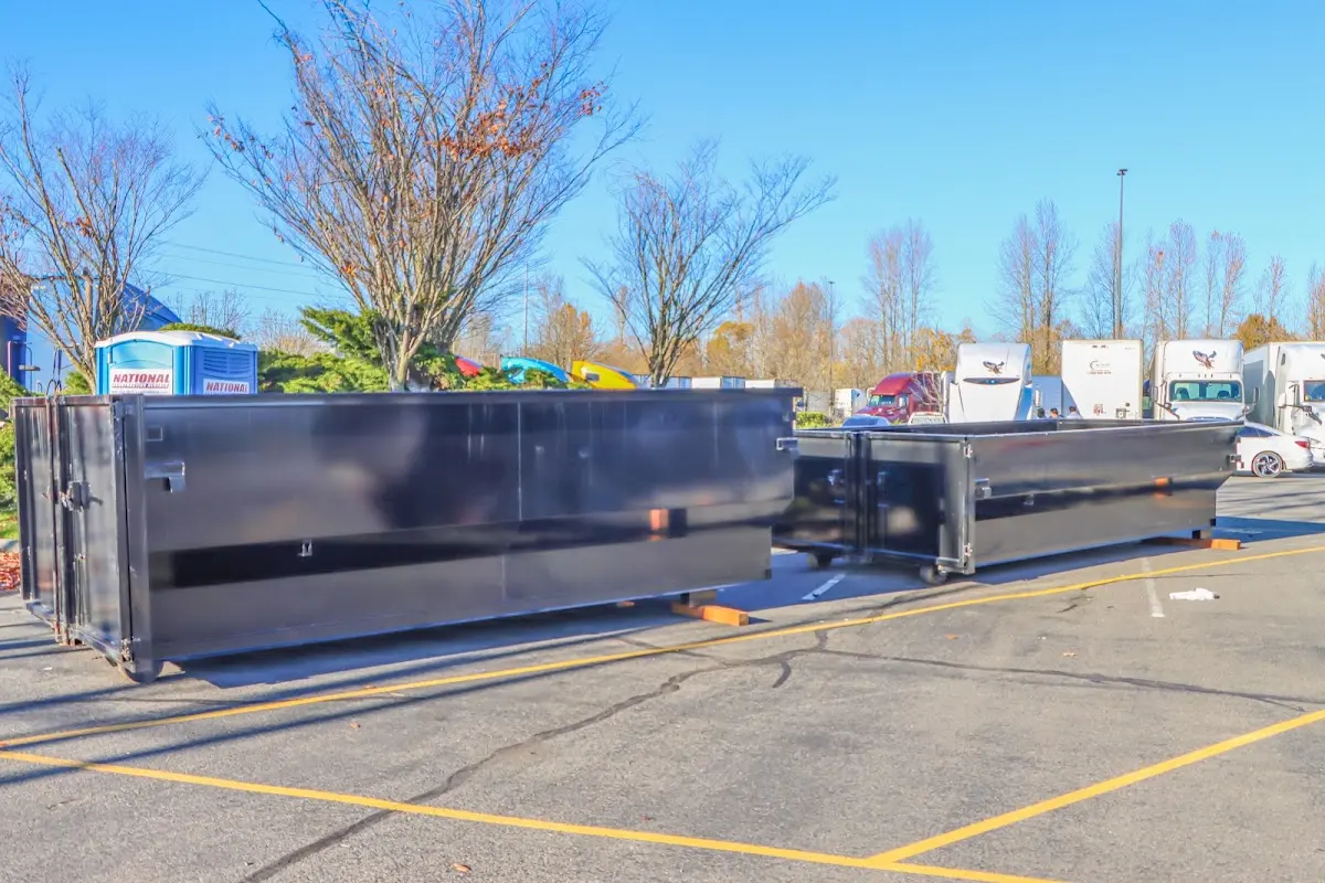 Professional dumpster rental service with roll-off container on residential driveway in Margaret